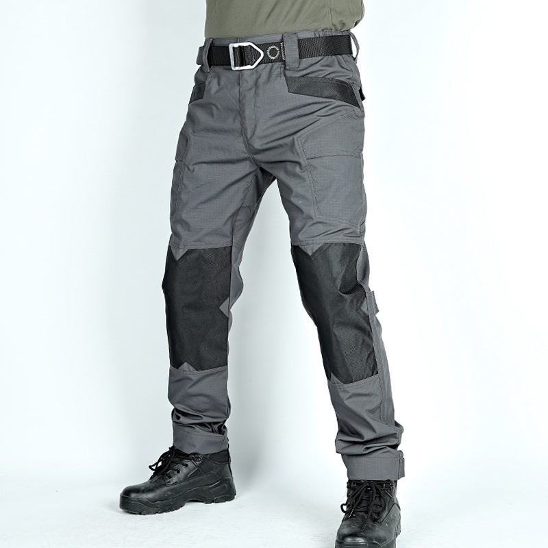 Gray tactical pants with black accents on a white background