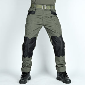Green and black tactical pants with a belt on a white background