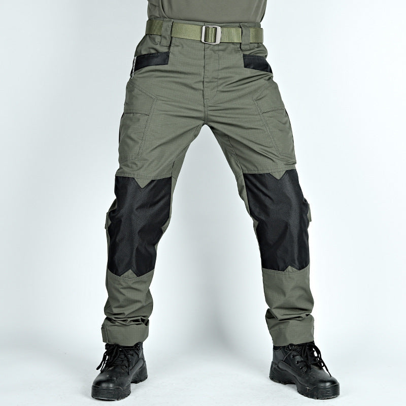 Green and black tactical pants with a belt on a white background