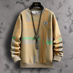 Plaid patterned sweater on a hanger against a textured gray background